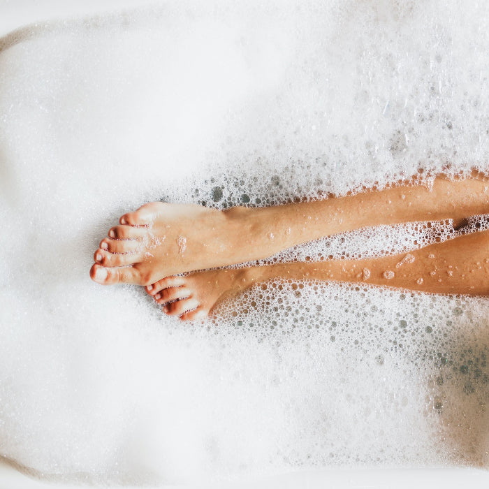 U Beauty Blog | How to Create an At-Home Spa | image of woman's legs in a bubble bath