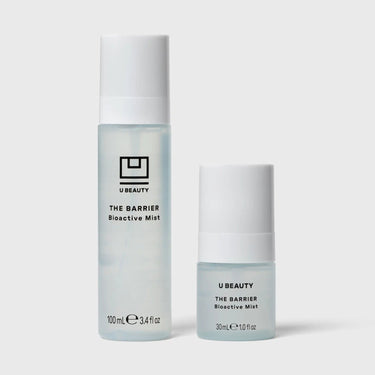 Two spray bottles of U Beauty The Barrier Bioactive Mist in 100ml and 30ml sizes with white caps.