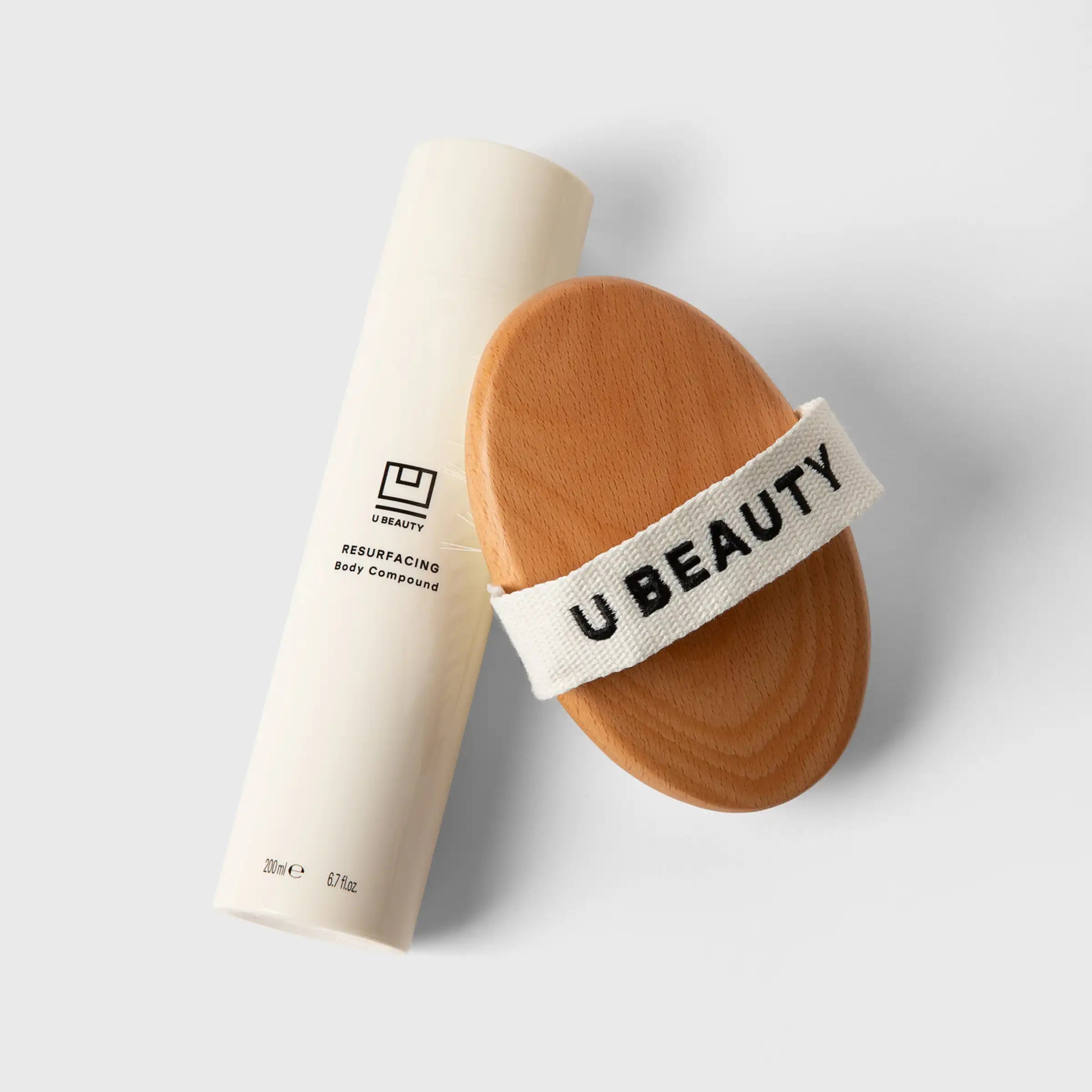 Oval dry brush with natural bristles and white fabric band labeled 