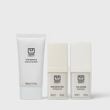 Three U Beauty skincare products: The Mantle Cleansing Balm tube, Resurfacing Compound bottle, and The Super Hydrator bottle
