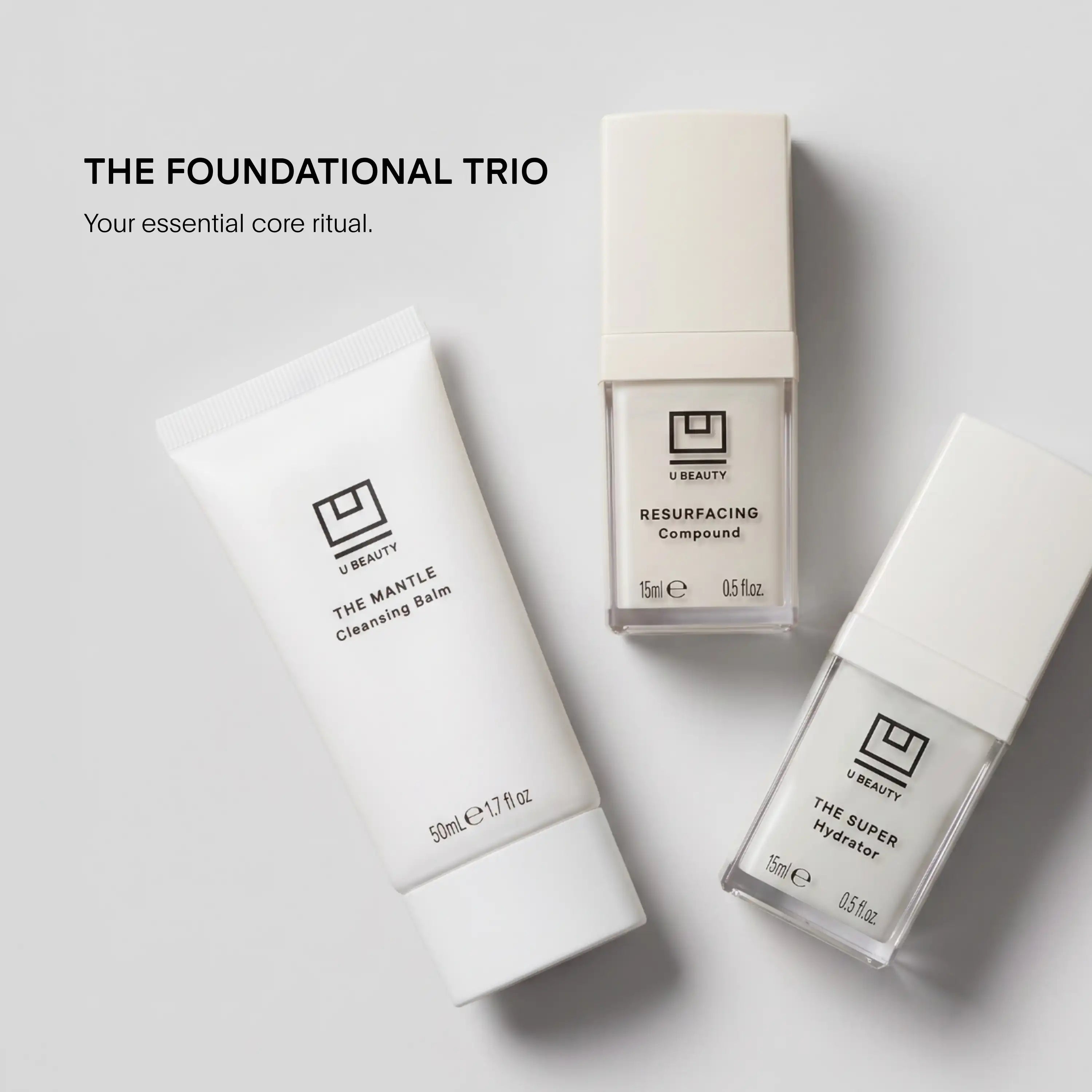 Three white U Beauty skincare products: The Mantle Cleansing Balm, Resurfacing Compound, and The Super Hydrator arranged on g