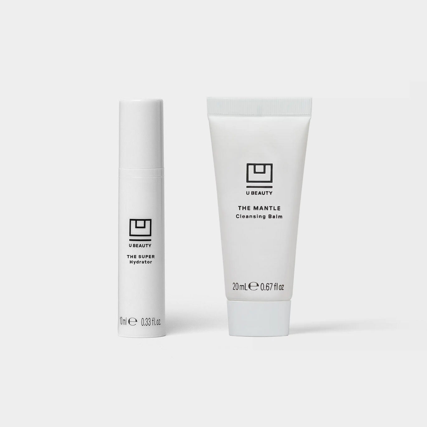 Two white U Beauty skincare products: a cylindrical tube labeled 