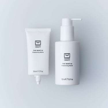 Two white U Beauty The Mantle Cleansing Balm containers: a 50ml tube and a 150ml pump bottle with black text labels.