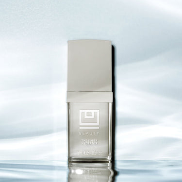 Clear glass bottle with cream-colored cap labeled "Beauty The Super Hydrator" 15ml, displayed against a light blue background