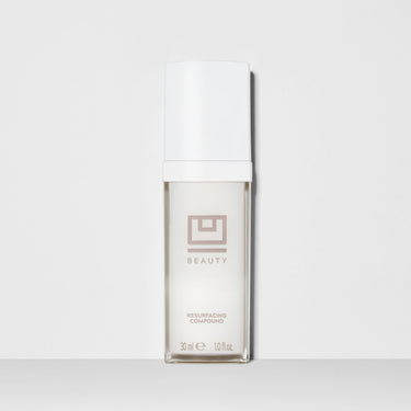 Two-piece set with white box and glass bottle labeled "Beauty Resurfacing Compound" 30ml, displayed against neutral backgroun