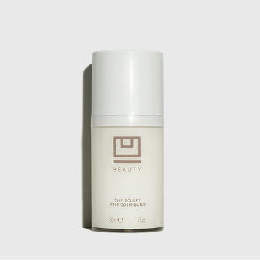 White cylindrical bottle labeled "The Sculpt Arm Compound" by U Beauty, 50ml size, with white cap on neutral background.