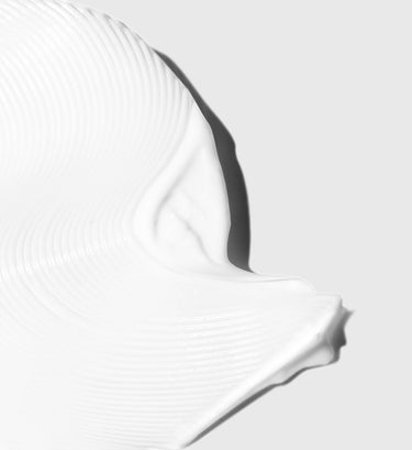Two white and black curved sculpting tools with ribbed handles displayed against a neutral background.